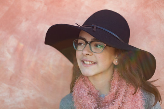 Smiling preteen girl wearing pink scarf