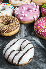 Donuts in a glaze assorted on a black background