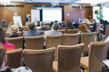 Business Conferences Concepts. People at the Law Conference Listening to The Host in Front of The Big Screen.