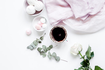 light breakfast with marsh-mallow and coffee on white table background top view