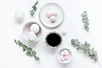 Fototapeta premium sweet lunch with marsh-mallow and spring flowers for woman on white background top view