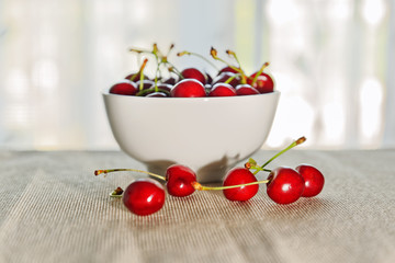 Cherries with full bowl in the background (selective focus)