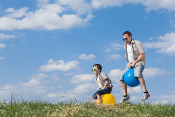 Father and son playing on the field at the day time.