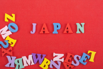 JAPANESE word on red background composed from colorful abc alphabet block wooden letters, copy space for ad text. Learning english concept.