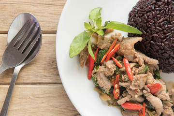 Spicy fried pork with basil leaves Served with riceberry rice,Thai style food