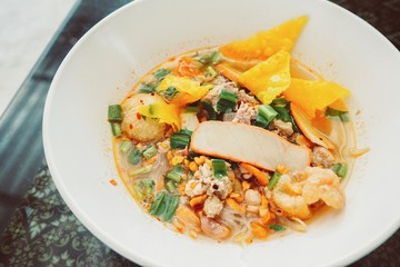 Thai-Style Spicy Tom Yum Noodle Soup in a White Bowl