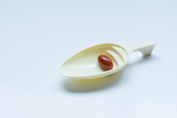 Medicine pills on spoon with white background, isolated.