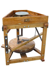 Brown wood potter's wheel isolated over white background © alexrow
