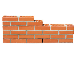 New red brick wall in construction process isolated on white