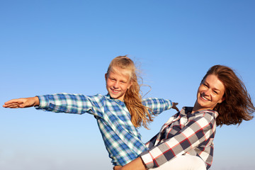  Parent and child smile, enjoy life and looking to camera. Closeup.