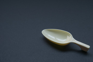 Medicine spoon over black background.