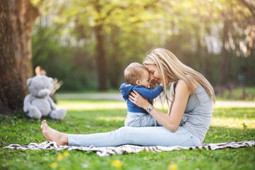 Delighted mother with her son outdoors in a park