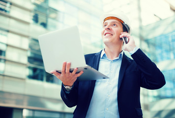 Smiling worker talking at mobile phone