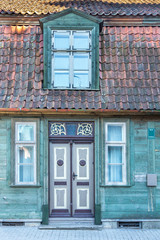 Fototapeta na wymiar Door, window, clay roof and green boards.
