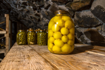 Preservation, pickles, marinades, in glass jars stand in the basement