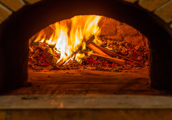 The fire burns in a wood pizza oven