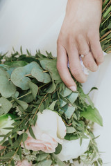 detail of green wedding bouquet in the hand of a bride