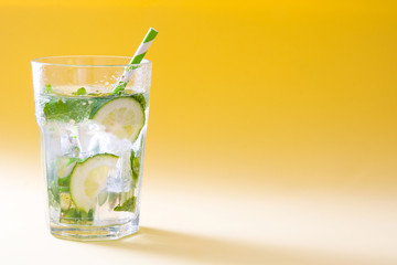 Mojito cocktail in glass on yellow background
