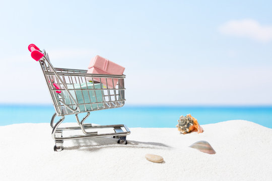 Summer shopping.  Business and selling on beach. Cart on white sand
