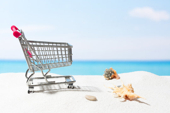 Summer shopping.  Business and selling on beach. Cart on white sand