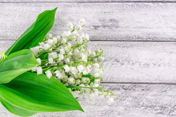 lily of the valley flowers on wooden background with copy space. Postcard, cover, card