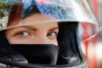 Poster Motorsport Young girl in a motorcycle helmet
