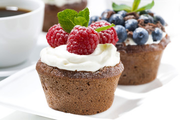 sweet chocolate cupcakes with fresh berries for dessert, closeup