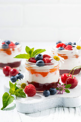 sweet dessert with jam, cream and fresh fruit, closeup vertical