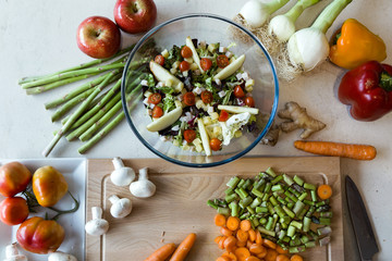 Salad with fresh vegetables in a bowl in the kitchen at home.