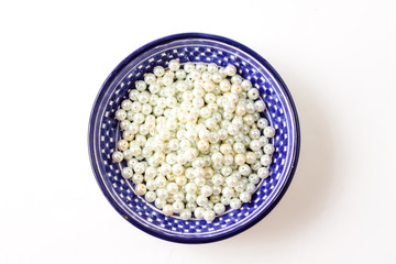 Color dish with beads, accessories for handmade jewelry. Top view