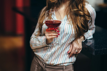 Portrait of a beautiful woman with a glass of wine in her hand
