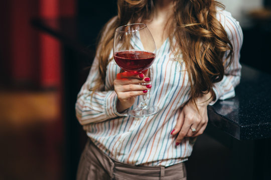 Portrait Of A Beautiful Woman With A Glass Of Wine In Her Hand