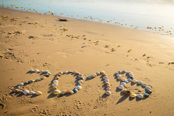 2018 New Year text on sand
