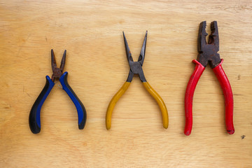 work tools wrench, pliers hand, pliers old,on a wooden table