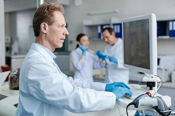 Fototapeta premium Serious technician looking at screen of computer