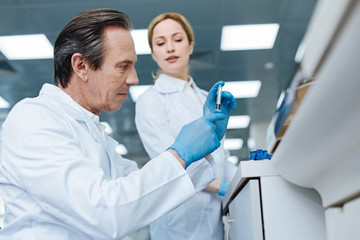 Fototapeta premium Portrait of confident practitioner while examining DNA