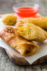 Vegetable spring rolls on wooden table background
