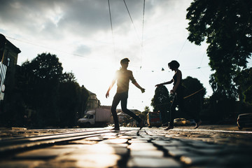 boy and girl run across the street holding hands
