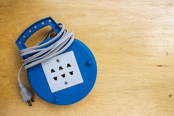Blue plug on a wooden table