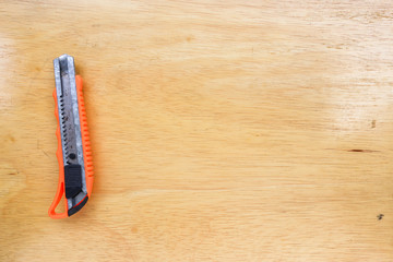 Obraz premium Cutter on wooden floor