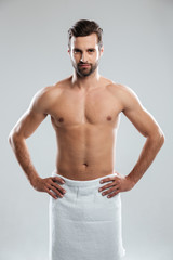 Fototapeta premium Man wearing towel looking camera