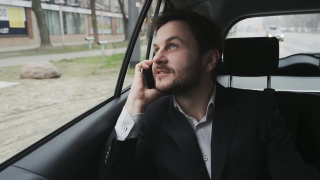 Young Businessman Ending a Phone Call in the Car