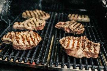 Grilled beef steak on the grill, close-up.