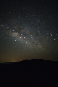 Milky Way over mountain at Phu Hin Rong Kla National Park,Phitsanulok Thailand, Long exposure photograph.with grain