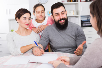 Parents signing property papers