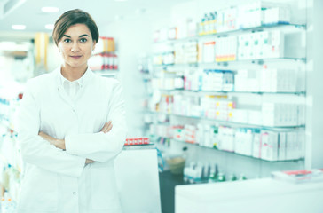 Female pharmacist arranging displayed assortment