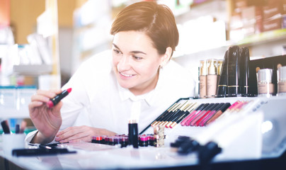 Customer browsing rows of cosmetic products