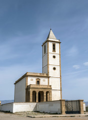 Fototapeta na wymiar San Miguel Beach and Salinas church with stranded boats, take in Cabo de gata, Almeria, Andalusia, Spain