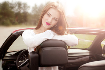 young pretty girl in red cabrio