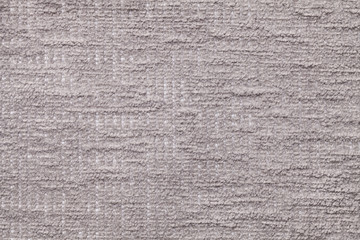 Fototapeta na wymiar Light gray fluffy background of soft, fleecy cloth. Texture of plush furry textile, closeup.
